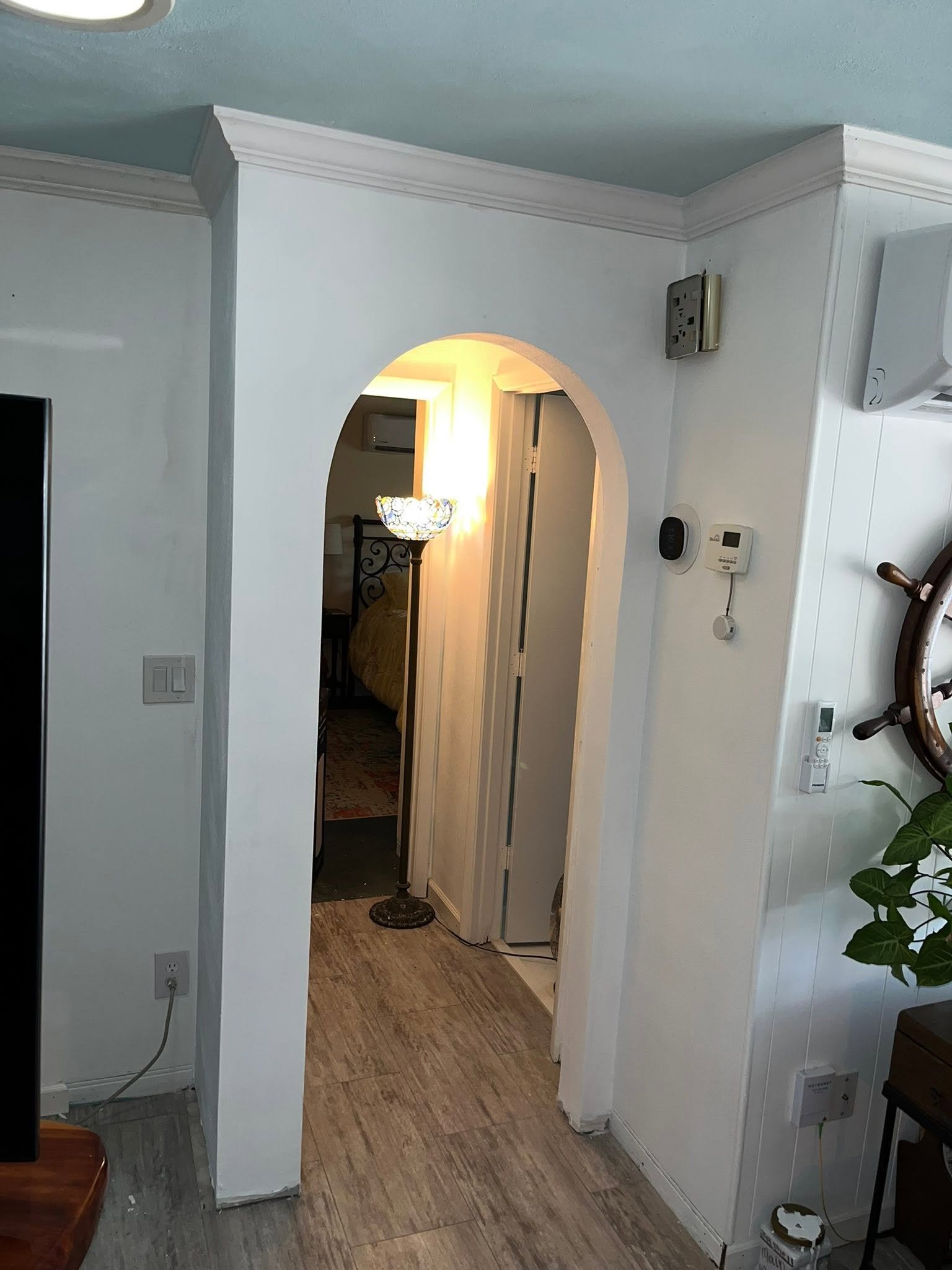 Finished arched doorway with crown molding after remodel