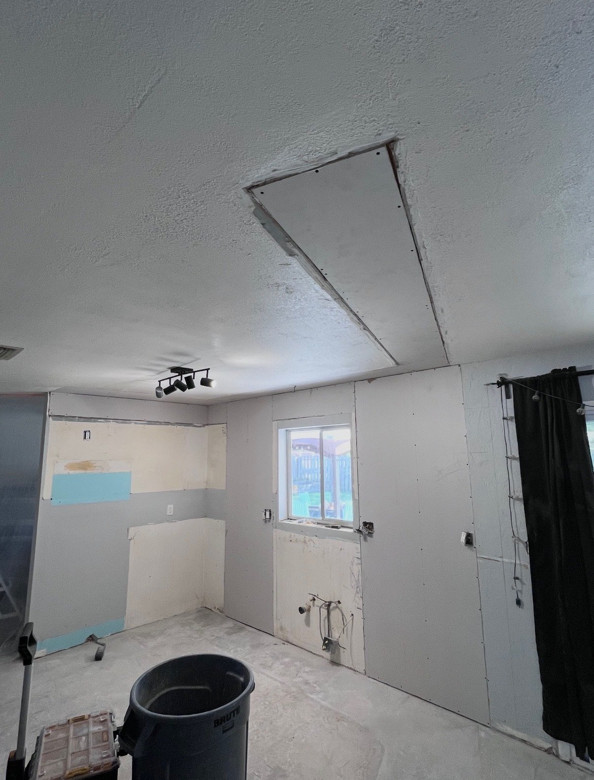 Drywall repair and patch work in a room under renovation