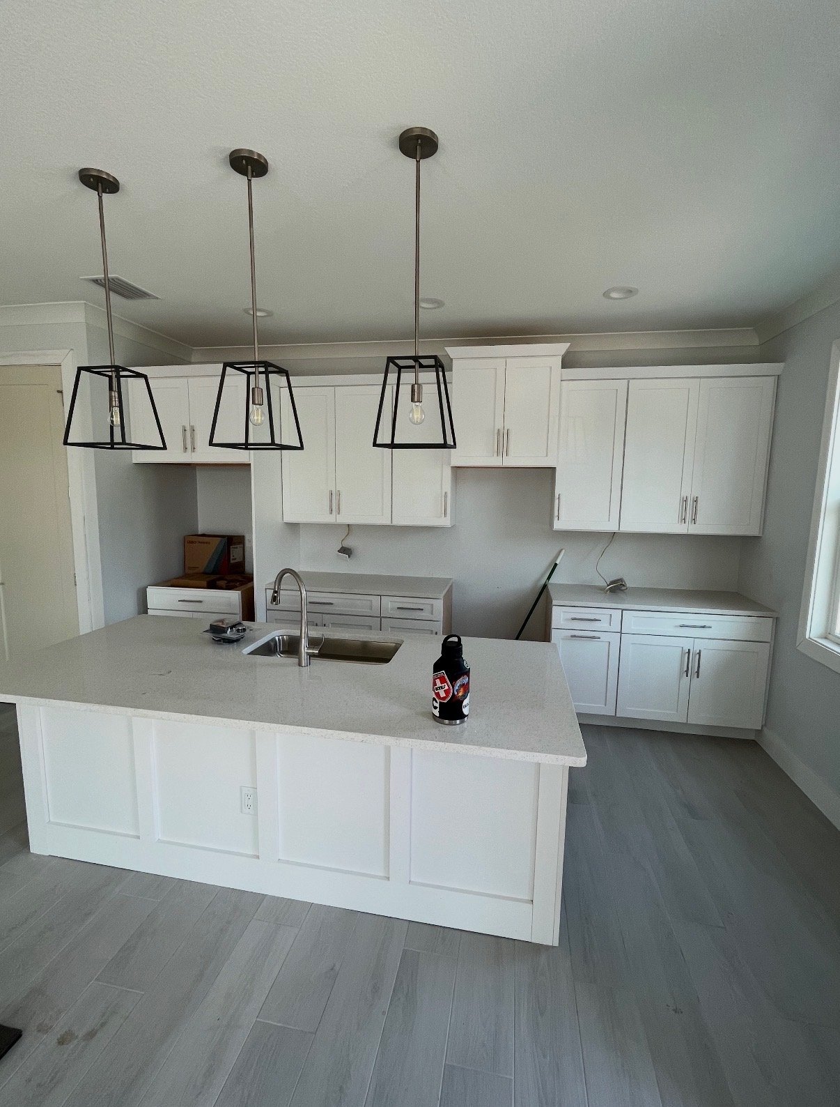New construction kitchen with island and pendant lighting