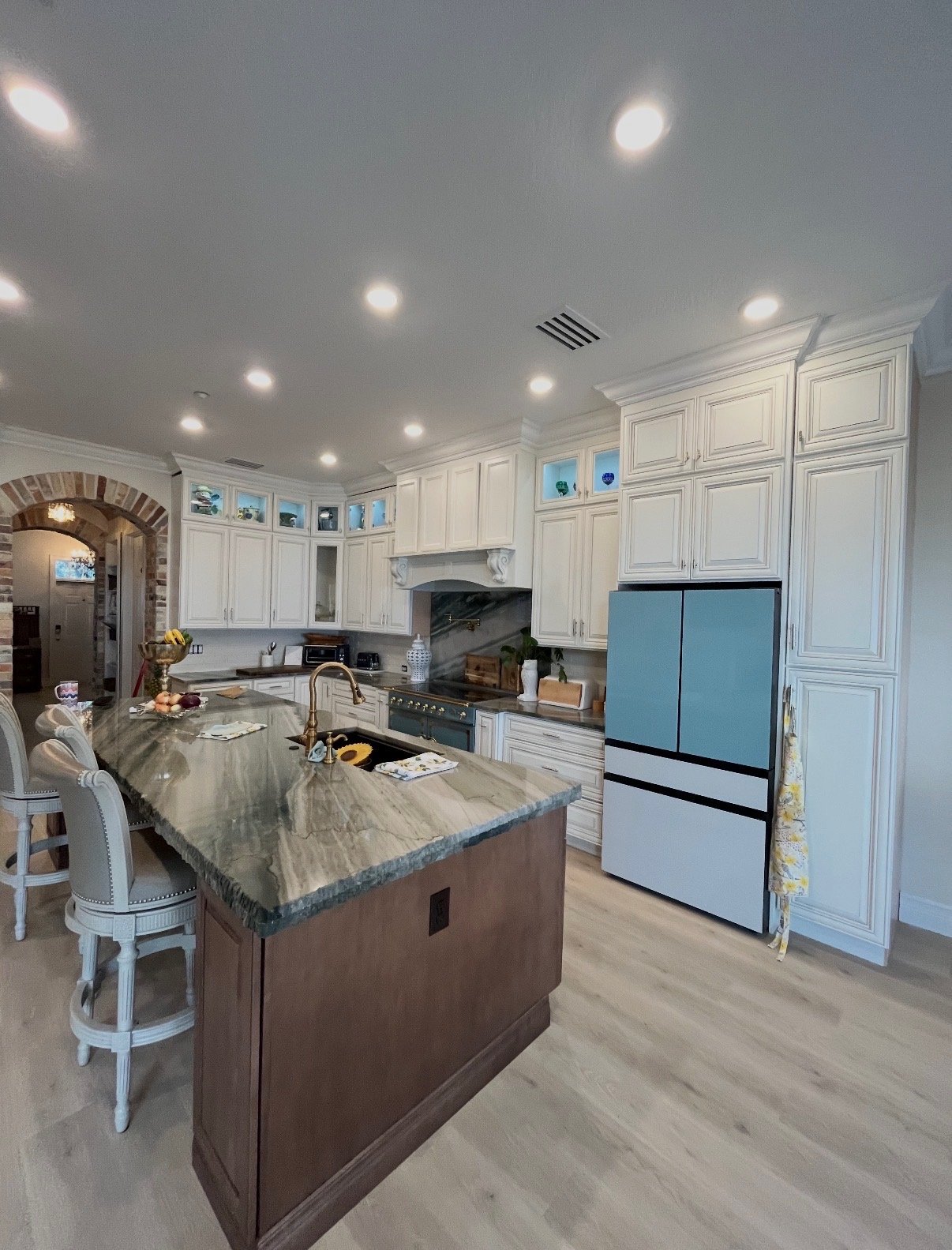 Kitchen with brick archway and marble island detail