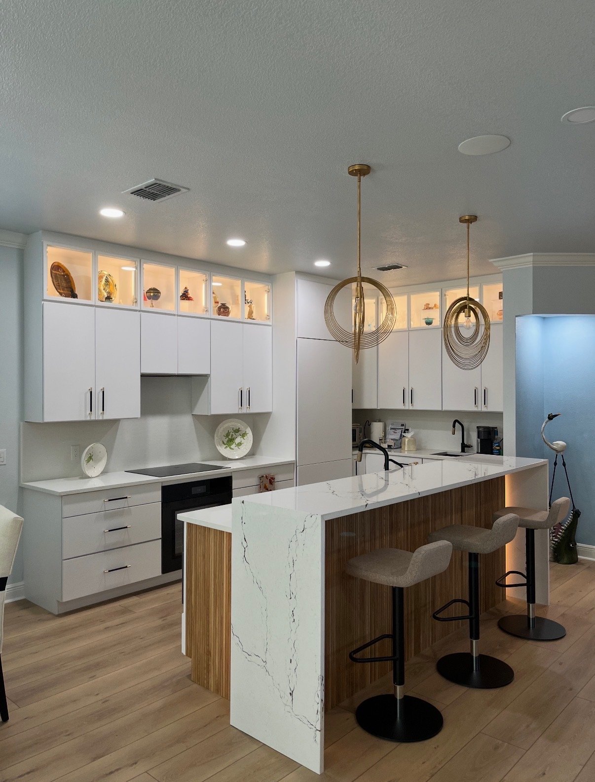 Modern kitchen with waterfall island and gold pendant lighting
